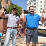 Oregon State Rep. Greg Smith, left, and Hermiston Mayor Drotzmann hand out free Hermiston potatoes at Pioneer Courthouse Square in Portland Saturday.