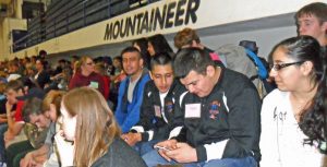 Isaac Murguria checks for text messages just prior to the relay competition. To his immediate right is Armando Mendoza and to his far right is Carlos Fonseca. To his left is Ana Mendoza.